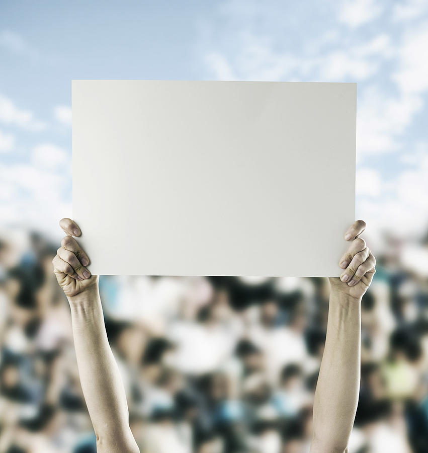 Person in crowd holding blank sign Photograph by Colin Anderson Productions pty ltd