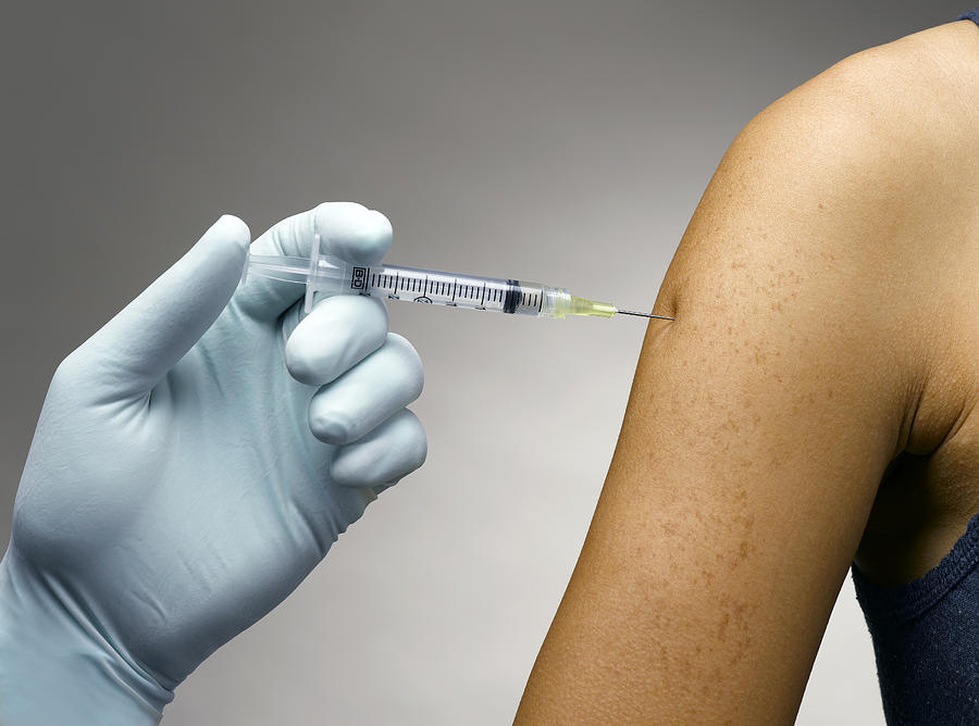 Person receiving a vaccine Photograph by Jeffrey Hamilton