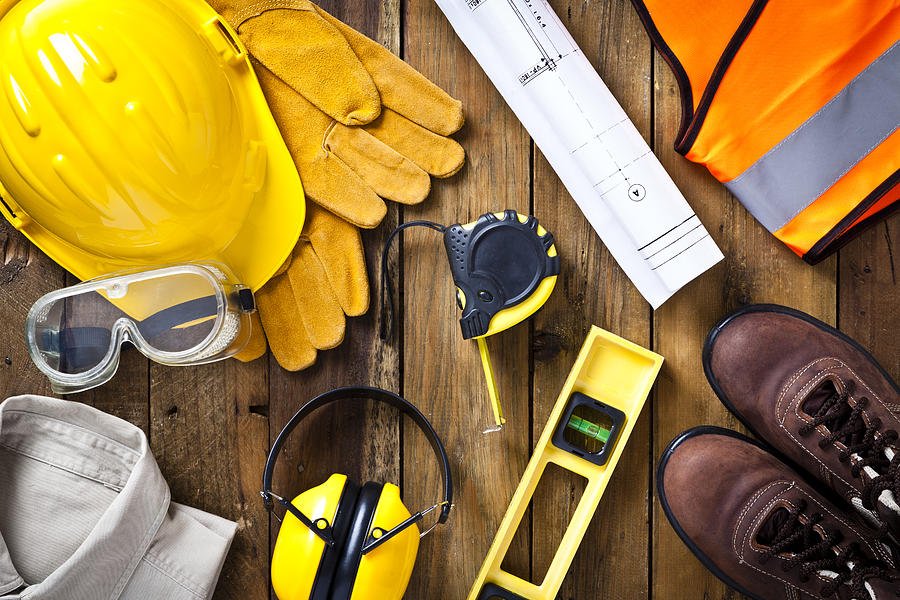 Personal safety workwear and construction blueprint shot directly above Photograph by Fcafotodigital