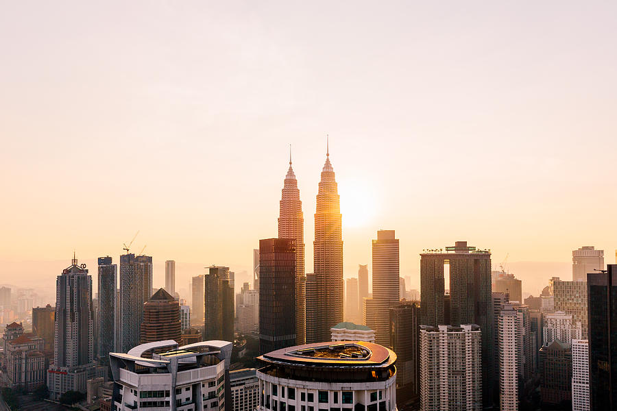 Petronas Towers and Kuala Lumpur skyline at sunrise, Malaysia Photograph by Alexander Spatari