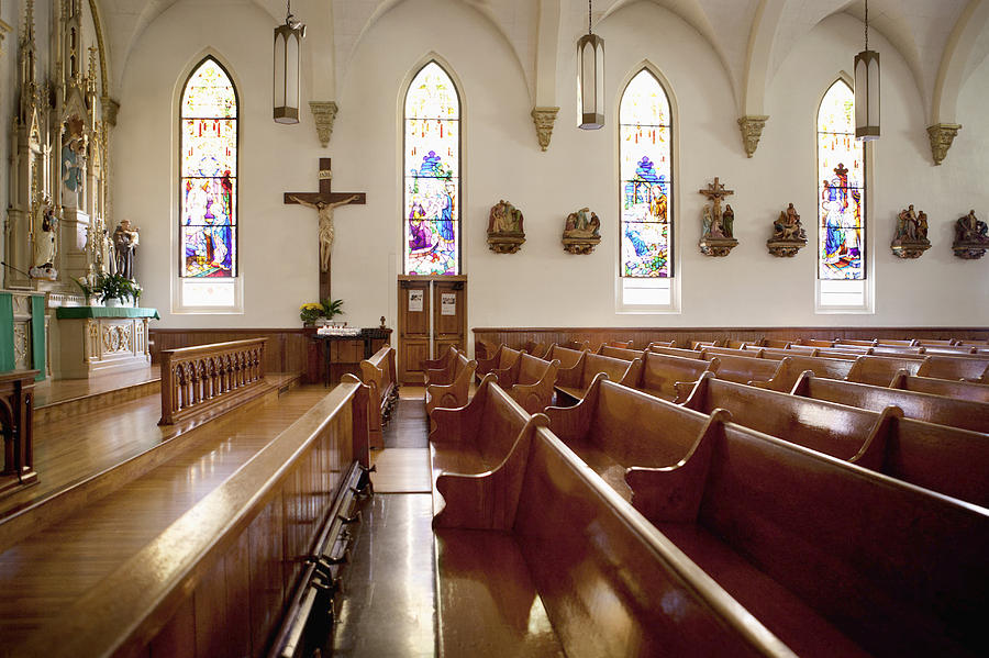 Pews and stained glass windows in church Photograph by Monashee Frantz