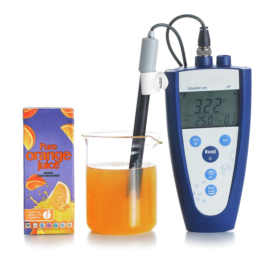 Ph Meter In Orange Juice Photograph by Science Photo Library