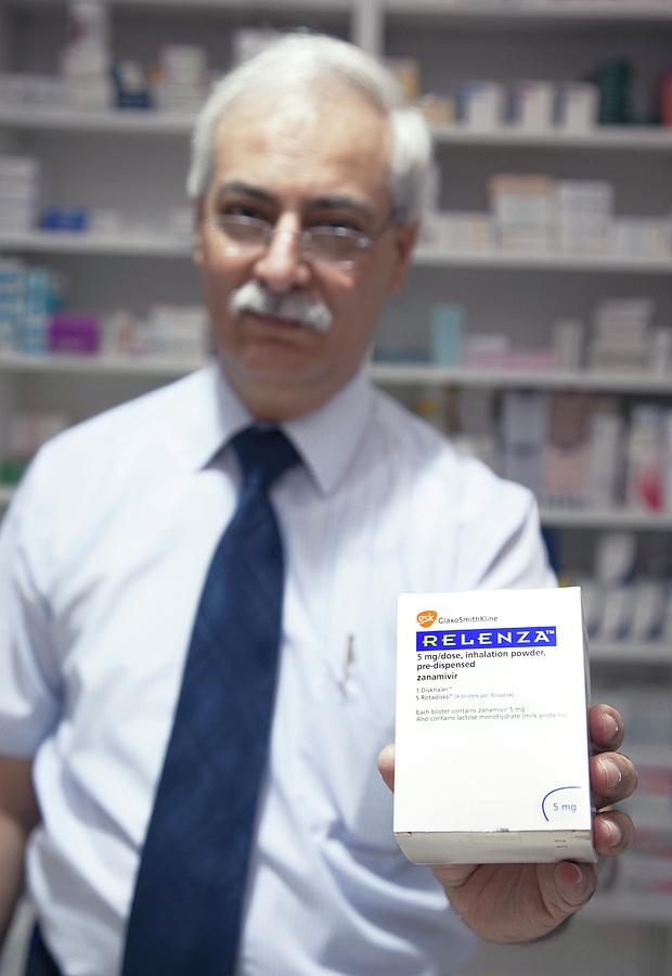 Pharmacist With Relenza Packet Photograph by Mark Thomas/science Photo Library