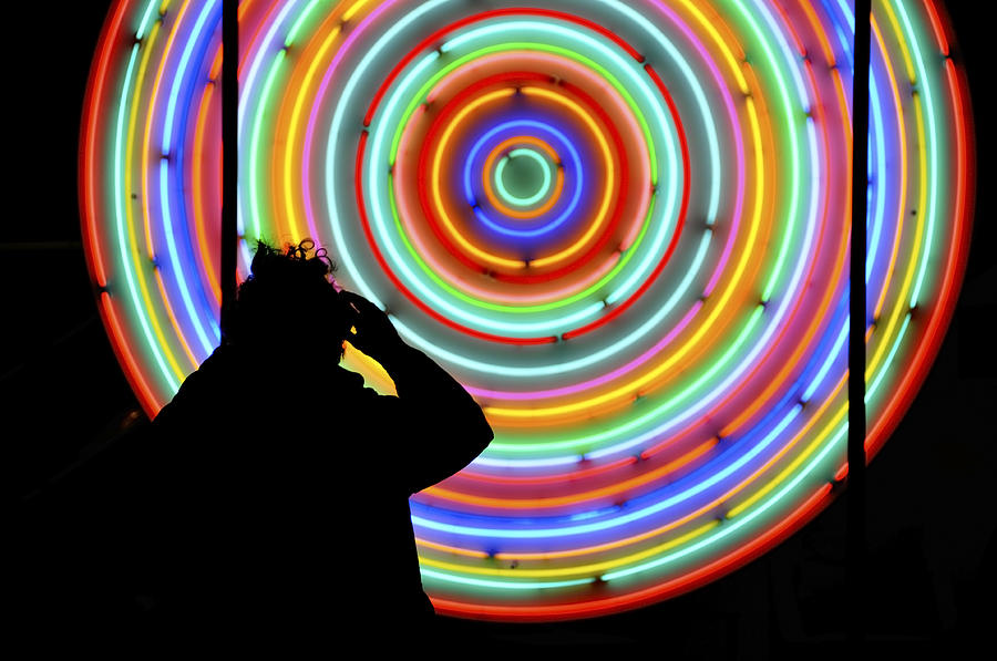 Photographer standing in front of neon lights circles Photograph by Dutourdumonde Photography