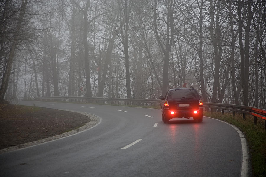 Picture of a car on the road on a gray day Photograph by Diephosi