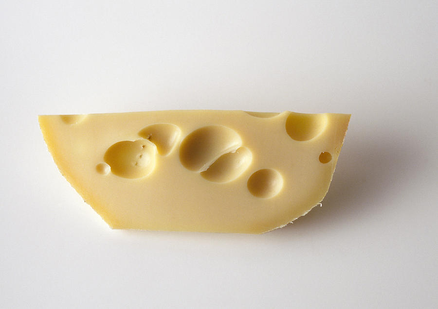 Piece of swiss cheese, close-up Photograph by Isabelle Rozenbaum & Frederic Cirou