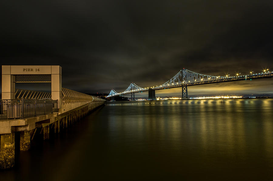Pier 14 and Bay Bridge at Night Photograph by John Daly