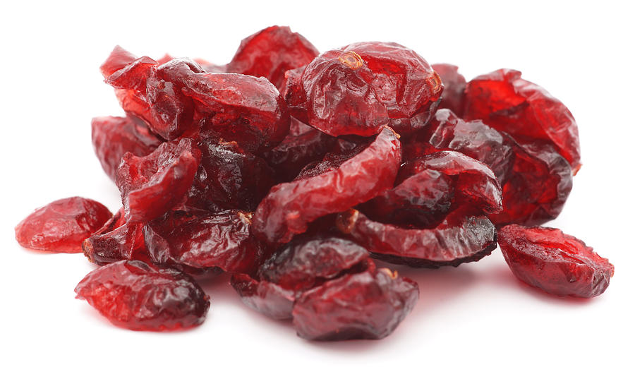 Pile of dried shriveled red cranberries on white background Photograph by Ermingut