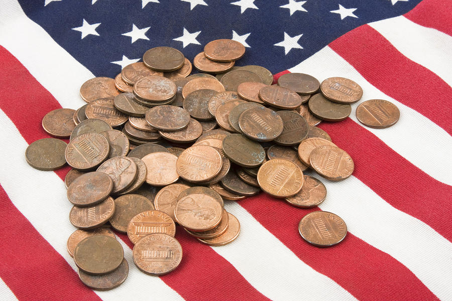 Pile of Pennies On American Flag Photograph by Keith Webber Jr