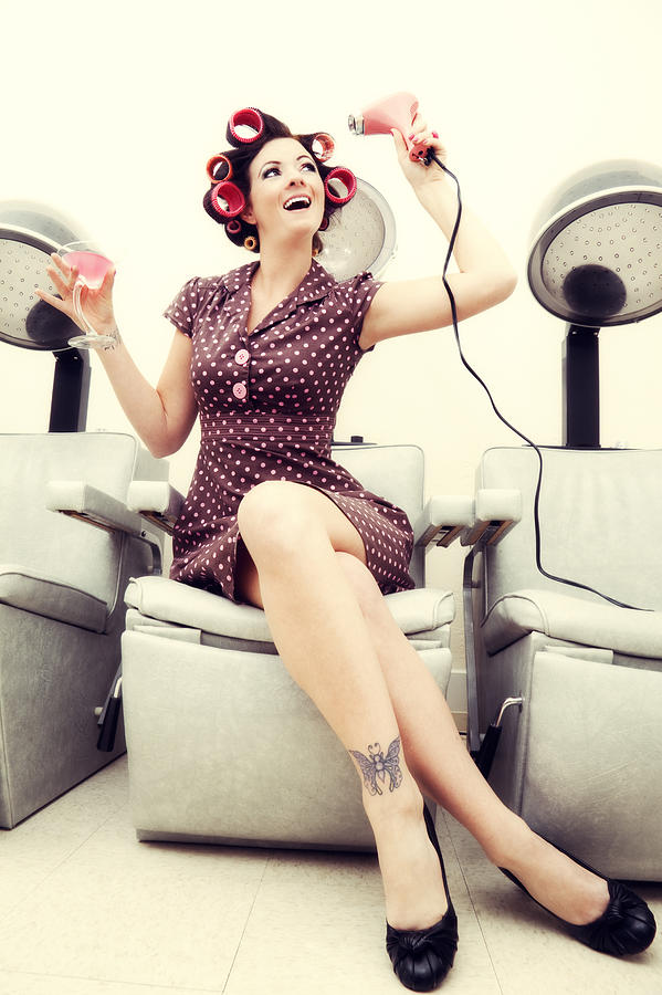 Pin-up girl: sexy woman wearing rollers in a beauty salon Photograph by Alina555