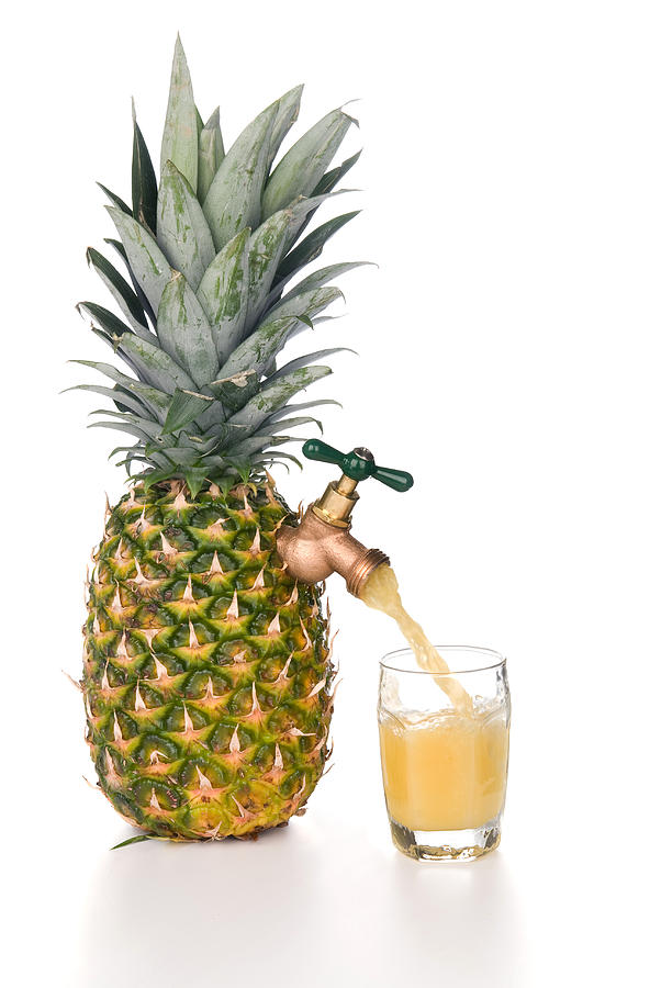 Pineapple juice pouring into glass Photograph by Joe Belanger - Fine ...