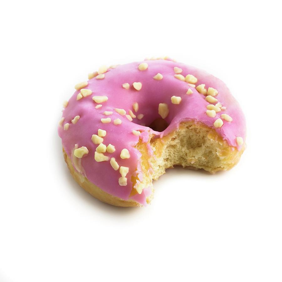 Donut Photograph - Pink Doughnut With Missing Bite by Science Photo Library