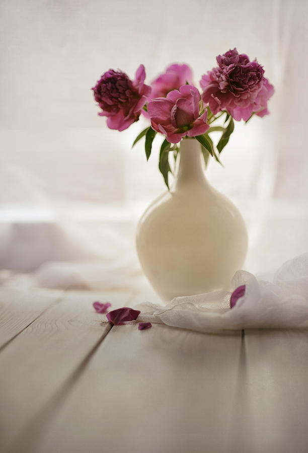 Pink peonies in a pot on the wooden table Photograph by Jaroslaw Blaminsky