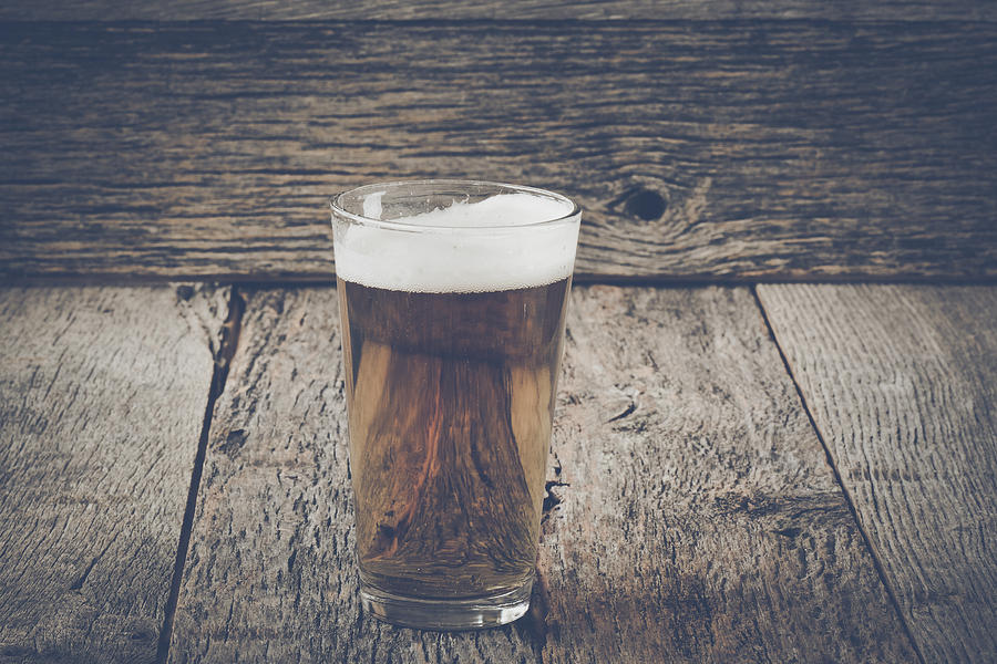 Pint of Pilsner Beer on Wood Background with Vintage Instagram F Photograph by Brandon Bourdages