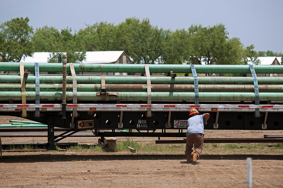 Pipes Being Loaded On To A Truck Photograph by Jim West