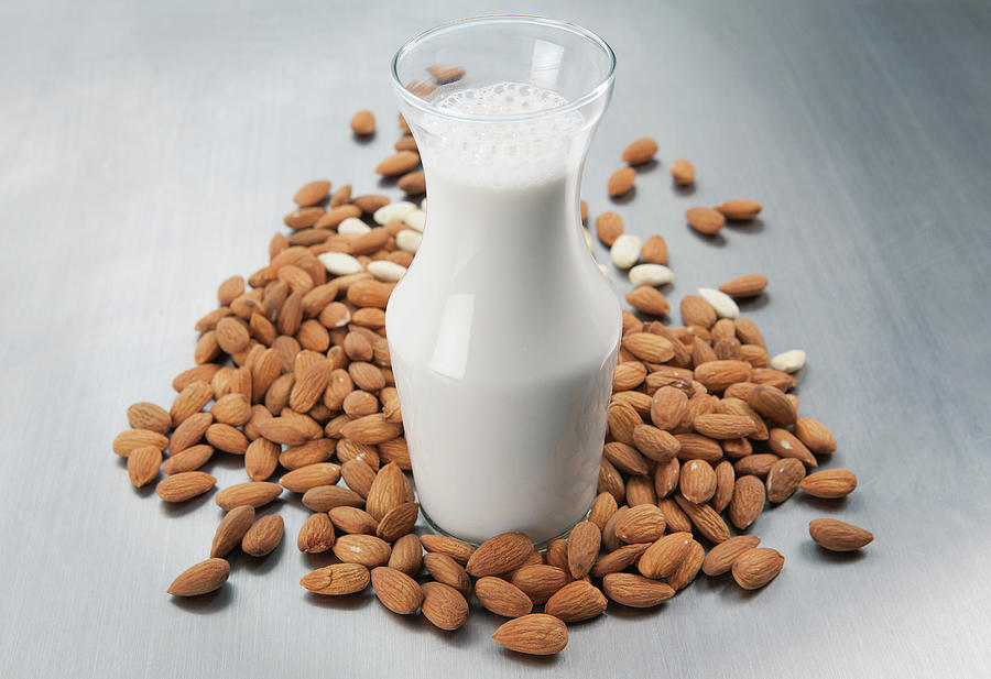 Pitcher Of Milk And Raw Almonds Photograph by Laurie Castelli