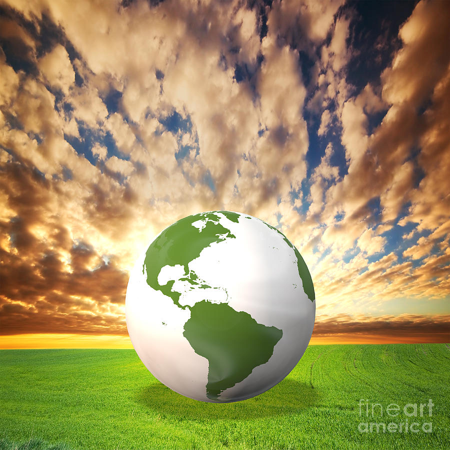 Planet Earth model on green field at sunset Photograph by Michal Bednarek