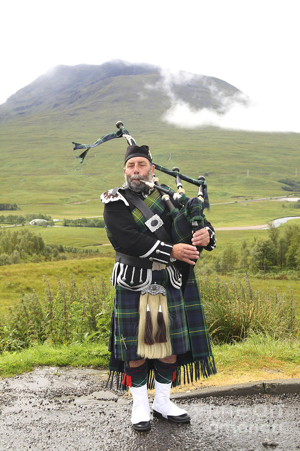 Music Photograph - Playing bagpiper in Highlands by Patricia Hofmeester