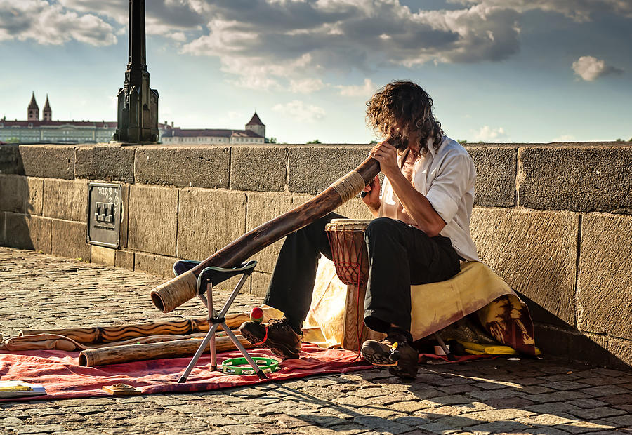 Playing Didgeridoo on the Charles Bridge. Prague Photograph by Jenny Rainbow