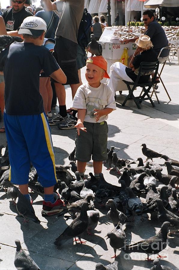 Playing with pigeons Photograph by Nora Boghossian