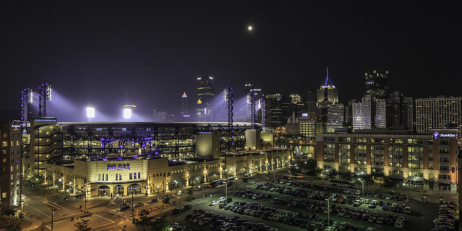 PNC Park is lit up at night during a Pittsburgh Pirates game - Metal Print