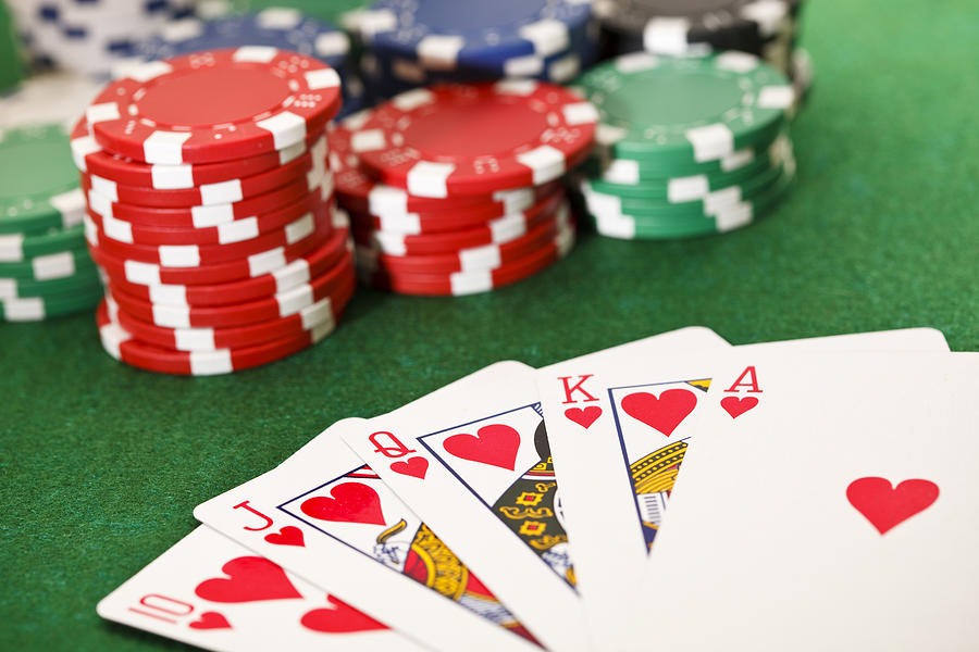 Poker, royal flush and gambling chips. Photograph by Leminuit