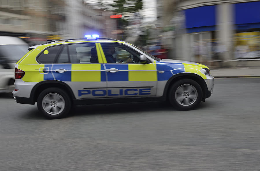 Police car on signal, blurred motion Photograph by Piccell