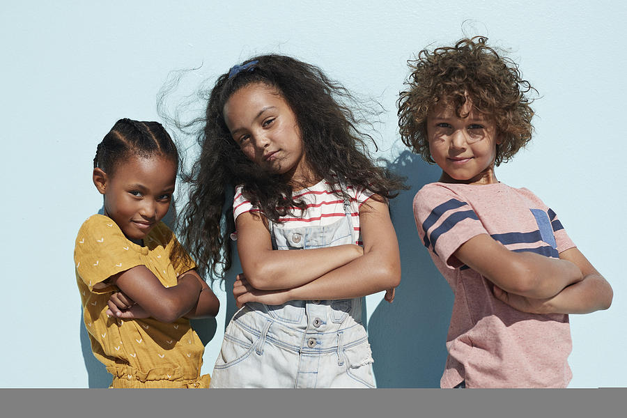 Portrait of 3 cool kids together on blue backdrop in summer Photograph by Klaus Vedfelt