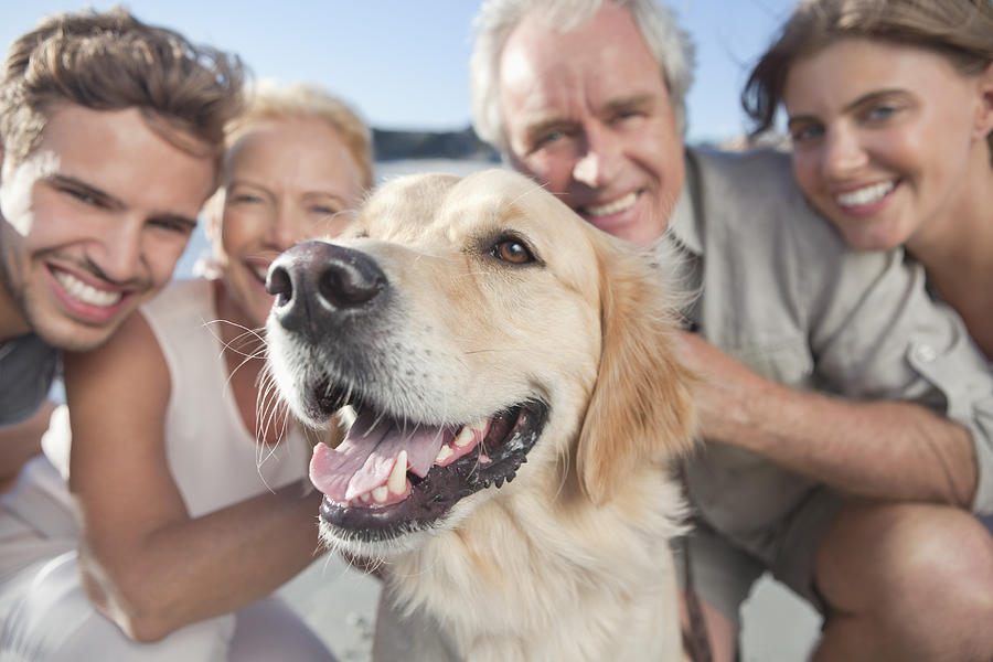 Portrait of a happy family with pet dog Photograph by OJO Images