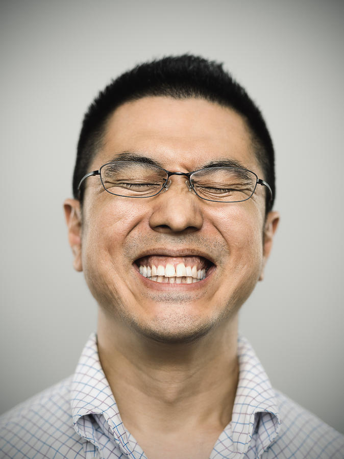 Portrait of a happy young japanese man looking at camera Photograph by SensorSpot
