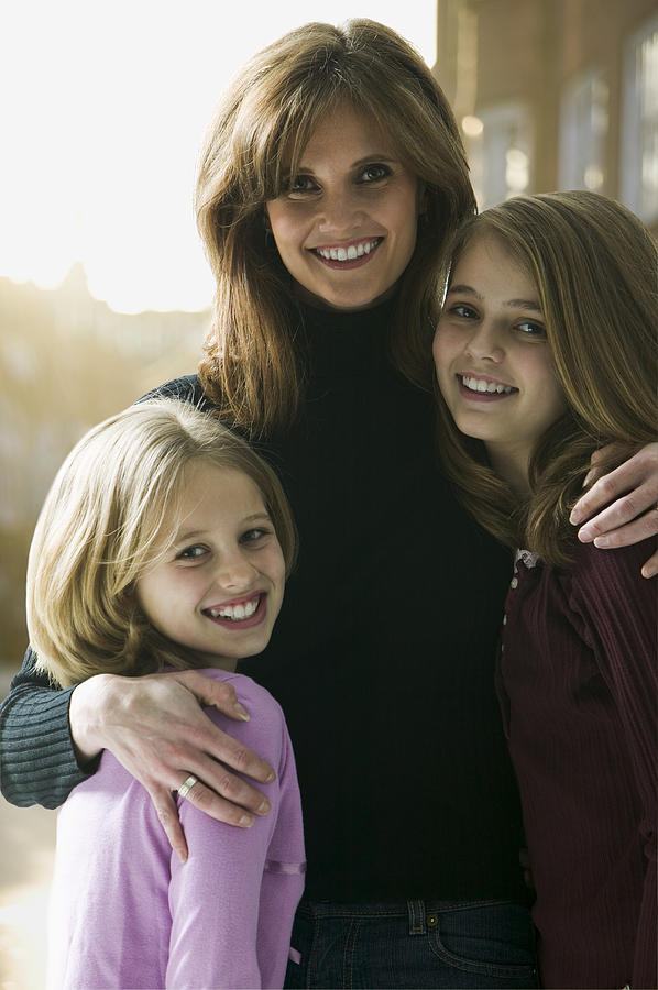 Portrait of a mid adult woman with her daughters Photograph by Photodisc