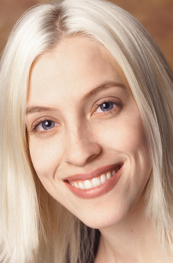 Portrait Of A Young Caucasian Blonde Woman As She Smiles At The Camera Photograph by Photodisc