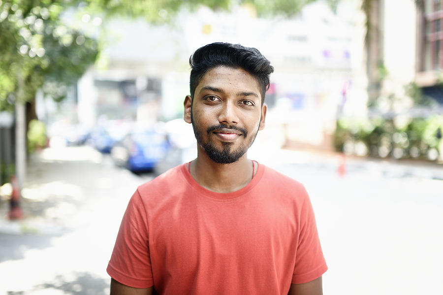Portrait of a young Malaysian Indian man on the street Photograph by Carlina Teteris