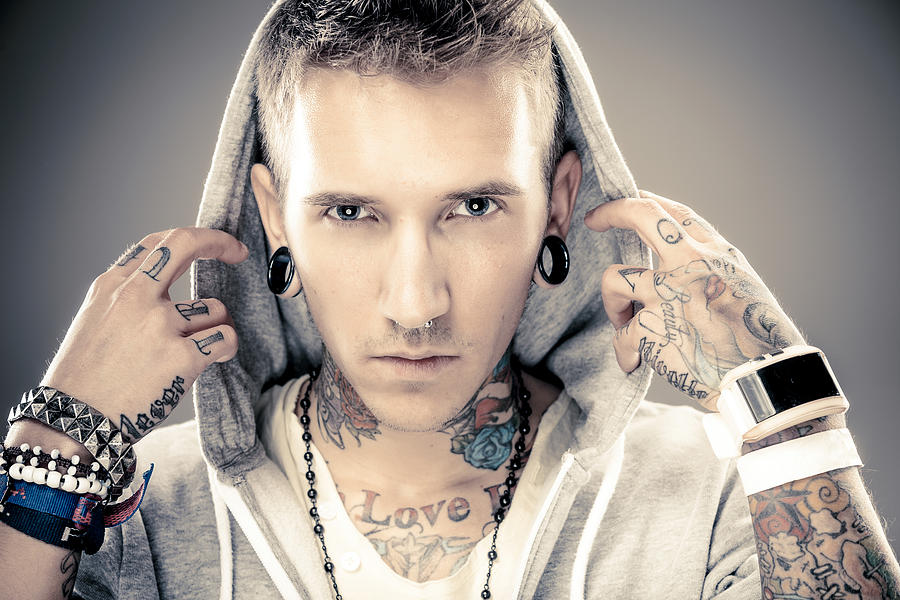 Portrait of a young male with many tattoos Photograph by Druvo