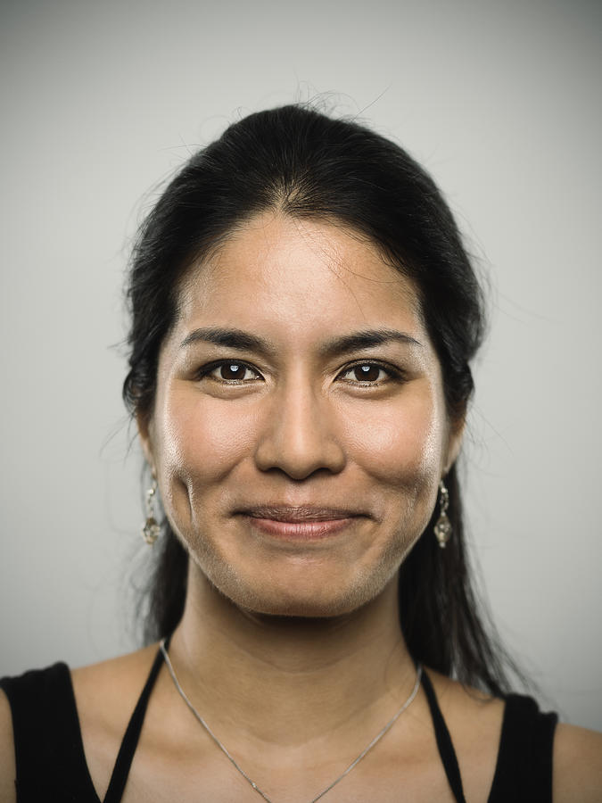Portrait of a young mixed race woman looking at camera Photograph by SensorSpot
