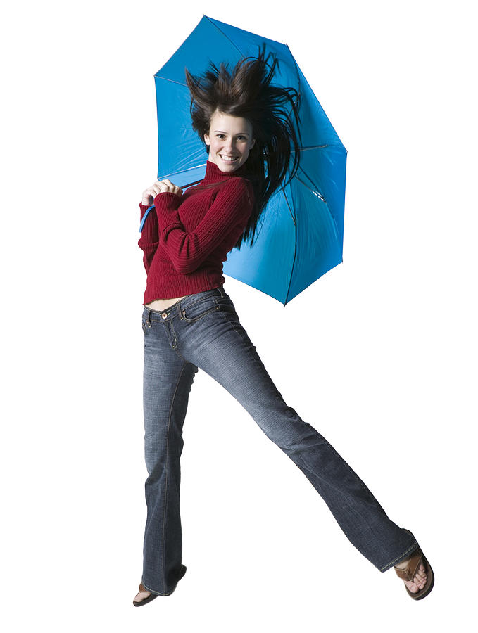 Portrait of a young woman holding an umbrella Photograph by Photodisc
