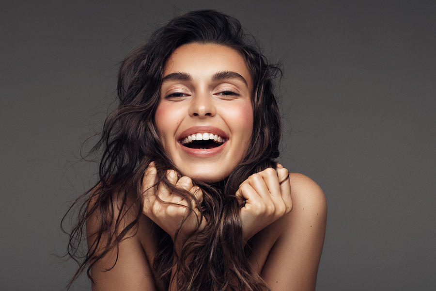 Portrait of a young woman with a beautiful smile Photograph by CoffeeAndMilk