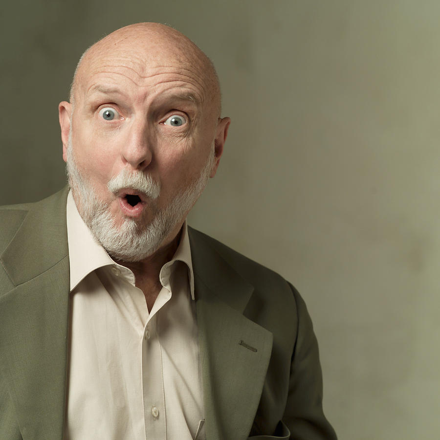 Portrait Of An Elderly Bearded Caucasian Man In A Olive Green Suit As He Looks Shocked And Surprised Photograph by Photodisc