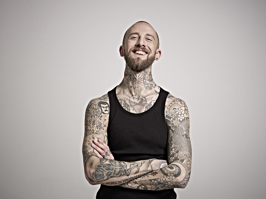 Portrait of bearded man with tattoos laughing. Photograph by Mike Harrington