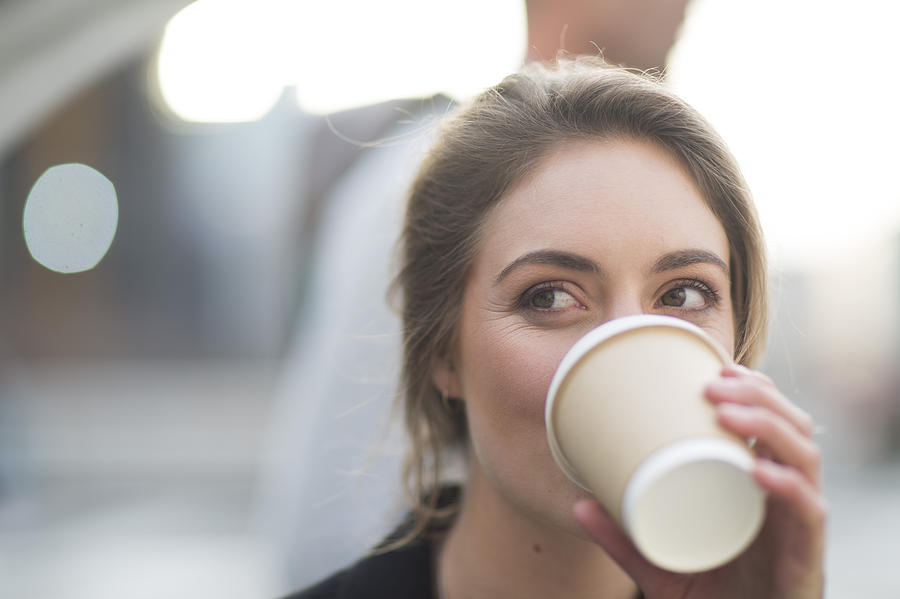 Portrait of businesswoman drinking coffee to go Photograph by Westend61