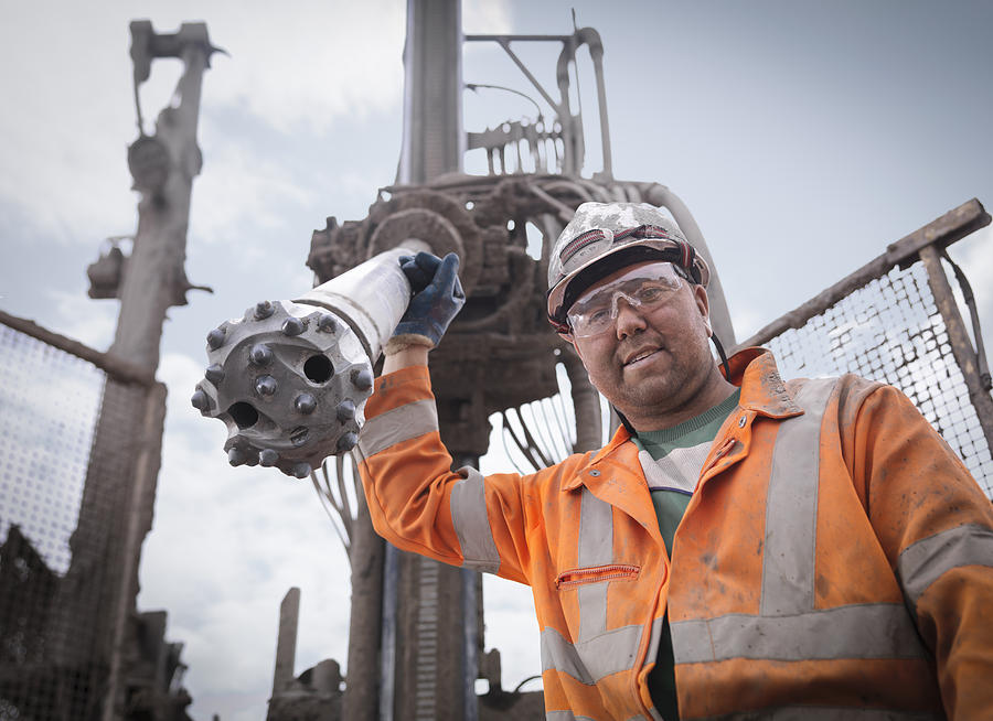 Portrait of drilling rig worker in hard hat and workwear Photograph by Monty Rakusen