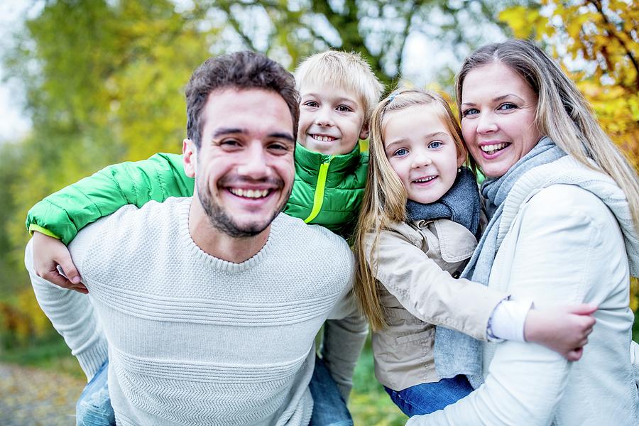 Portrait Of Family Enjoying In Autumn Photograph by Science Photo Library