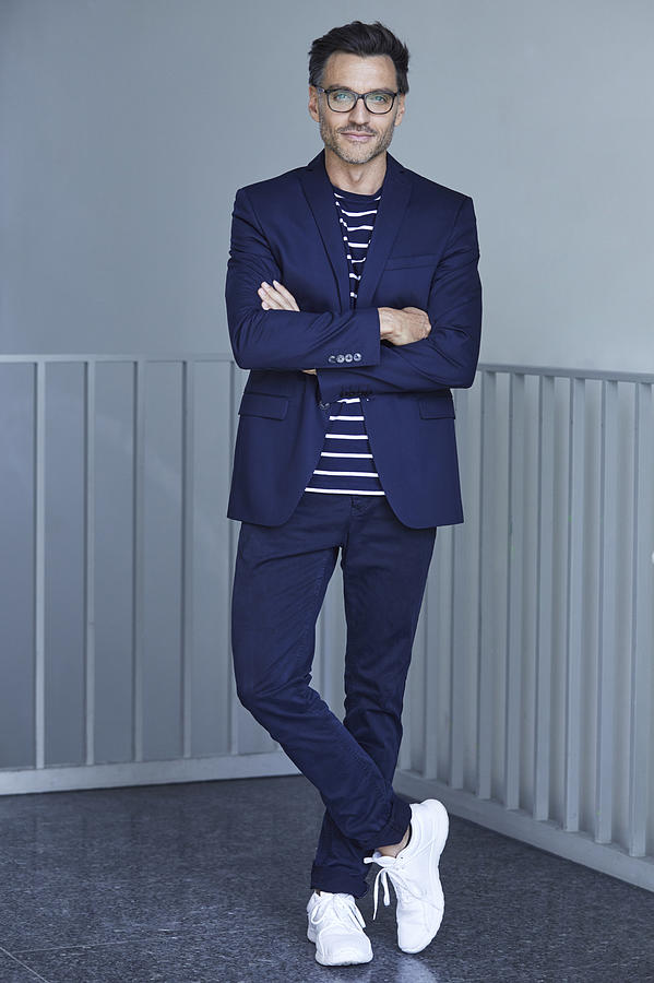 Portrait of fashionable businessman with wearing blue suit and glasses Photograph by Westend61