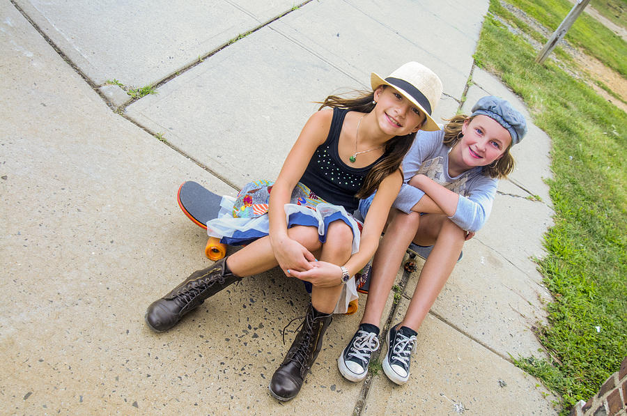 Portrait of girls sitting on skateboards Photograph by Sue Barr