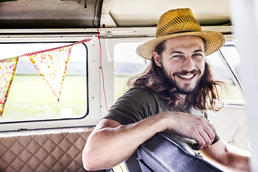 Portrait of happy young man inside a van Photograph by Westend61