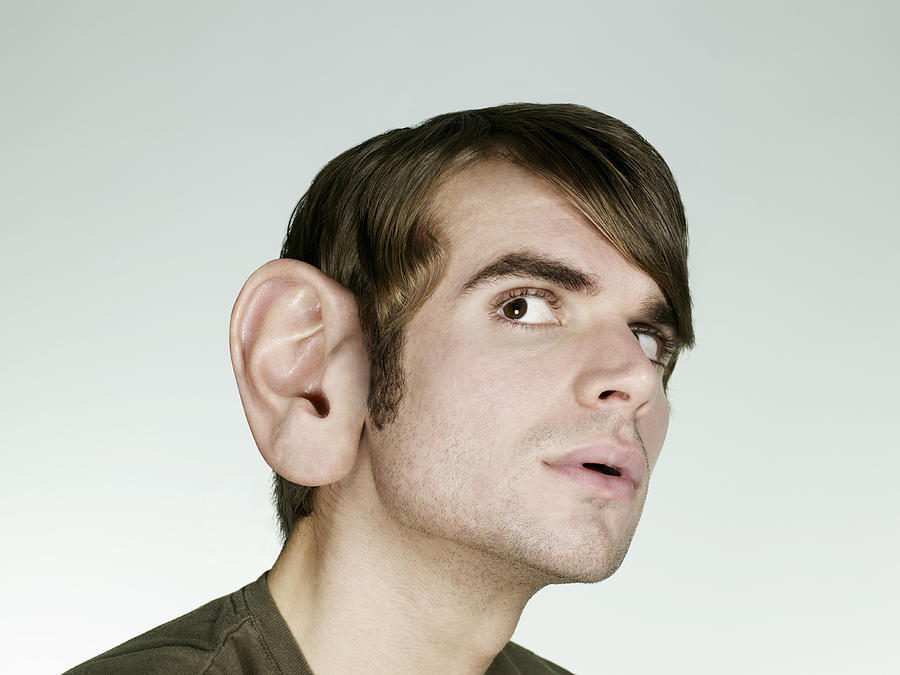 Portrait of man with big ear listening Photograph by Flashpop