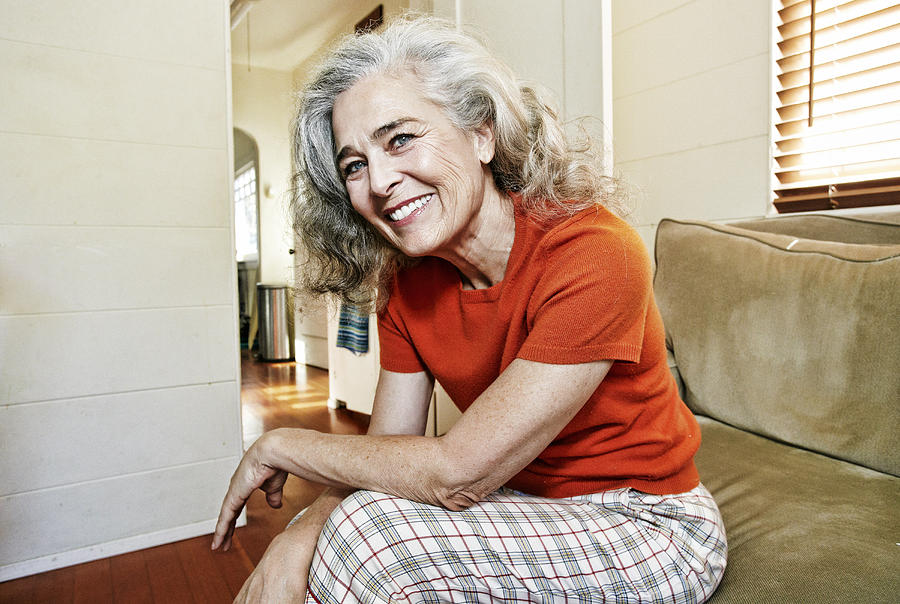 Portrait of older Caucasian woman sitting on sofa Photograph by Peathegee Inc