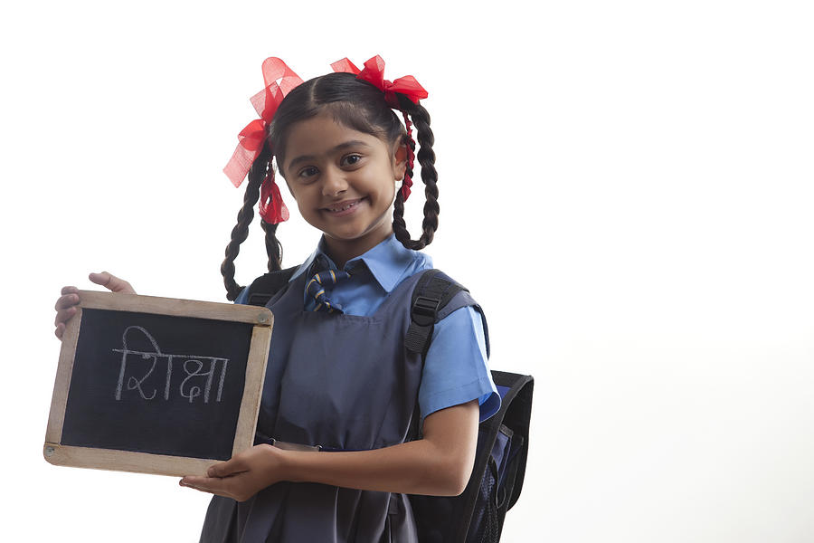 Portrait of school girl holding slate Photograph by Hemant Mehta
