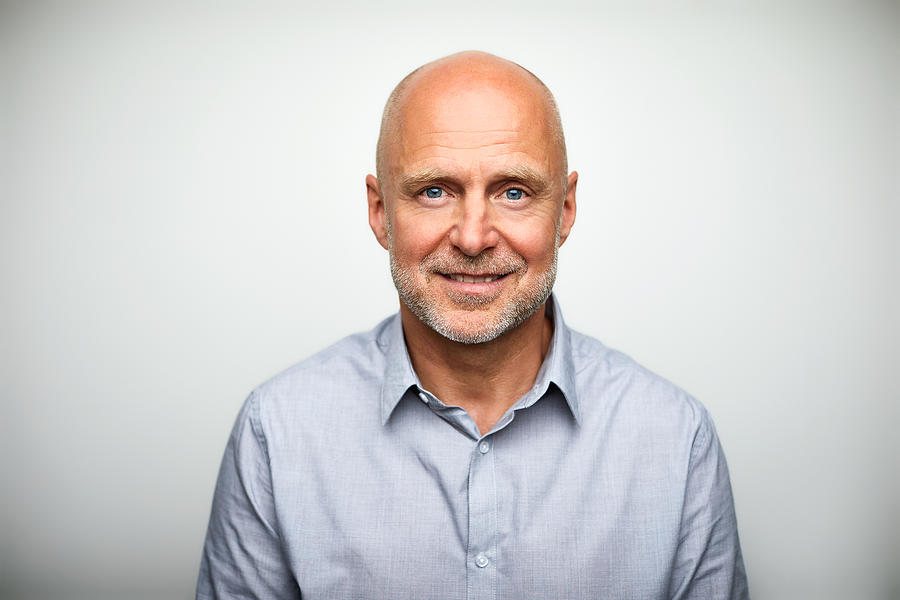 Portrait of senior businessman smiling Photograph by Morsa Images