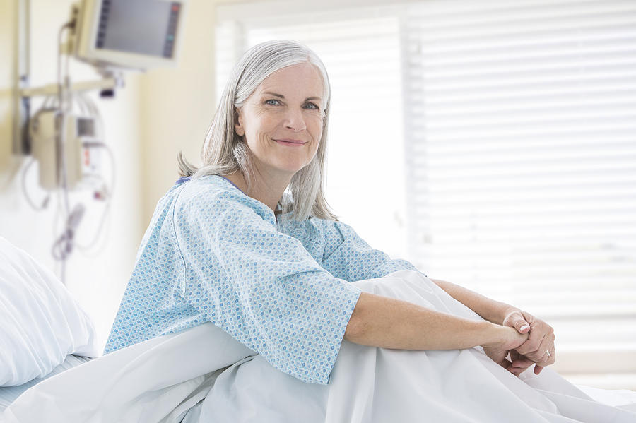 Portrait of smiling Caucasian woman in hospital bed Photograph by Mike Kemp